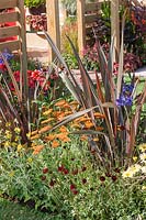 Perennial border with Phormium in the summer