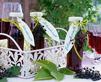Bottles of juice from berries of Sambucus ( elderberry ) on metal tray