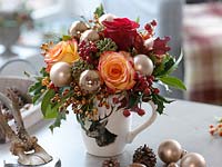 Hirsch cup as a vase with pink ( roses, rose hips ), Hedera ( ivy ) and Ilex