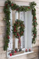 Christmas decorating windows with garland and wreath