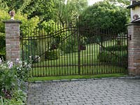 View of the garden by wrought iron gate