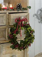 suspended wreath of Ilex ( Holly ) to the cabinet