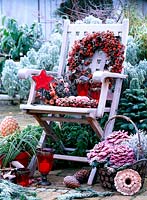 Wooden chair with pink - rose hips wreaths, Physalis - lanterns basket with Brassica