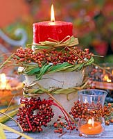 Candles arrangement with wreaths of pink ( rose hips )