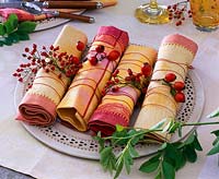 Napkins made of fabric decorated with pink ( rose hips ) on