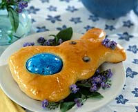 Table decoration - Easter bunny made of yeast dough with boiled egg and