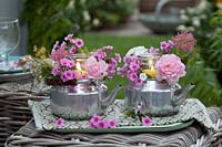 put tall glasses as votives in silver teapot,