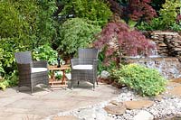 Natural stone terrace with wicker garden furniture