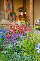 Colorful Perennial border with garden furniture