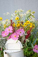 Bouquet with fall flowers in watering can
