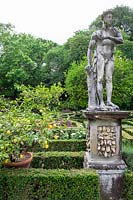 Parterre area with Lemon trees in pots and statues at the garden at Palazzo Corsini, in Florence, Italy