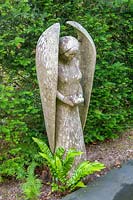 Caervallack, Cornwall, UK. ( McClary/Robinson ) Artists garden in summer, carved Angel against yew hedge