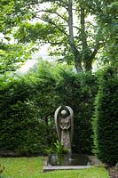 Caervallack, Cornwall, UK. ( McClary/Robinson ) Artists garden in summer, the carved angel in the 'Angel Garden'