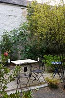 Caervallack, Cornwall, UK. ( McClary/Robinson ) Artists garden in summer,outside table and chairs in shady back garden