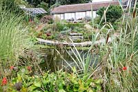 Derry Watkins Garden at Special Plants, Bath, UK well stocked medium sized pond