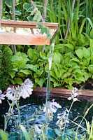 Hampton Court Flower Show 2014, the Vestra Wealth Garden, des. Paul Martin., water spout in contemporary garden