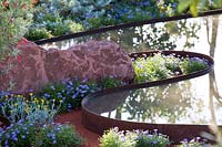 Hampton Court Flower Show 2014, the Essence of Australia Garden, des. Jim Fogarty. Curved reflective water feature pond