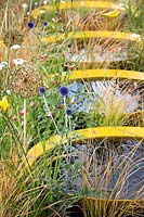 Hampton Court Flower Show, 2017. Kinetica Garden, des. Senseless Acts of Beauty. Small circular ponds reflecting grasses and seed heads