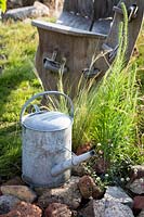 Hampton Court Flower Show, 2017. The Power to Make a Difference Garden, des. Joe Francis.  Watering can in garden