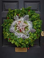 Beautiful Christmas wreath hung on period front door