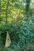 Pinsla Garden, Cornwall, UK. Late summer garden , ornamental obelisk in woodland garden