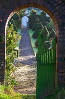 Perrycroft, Herefordshire. ( Archer ) view through gateway to Yew topiary,( PR available )