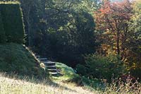 Perrycroft, Worcs. in autumn.  Gillian Archer's garden. steps lead into woodland garden