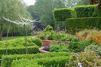 Mitton Manor, Staffordshire. Formal garden parterre with Neil Wilkin glass 'Suncatcher' sculptures