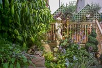 68 Kensington Rd, Bristol ( Gren Johnson ) Small town garden, packed with plants in pots. raised decking and statue of Pan