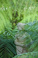 Beechwell Garden ( Tim Wilmot ), Bristol, UK.statue hidden amongst foliage