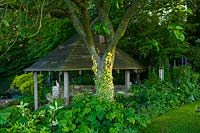 Trench Hill garden, Gloucestershire, UK ( Hargraves ) tiled summerhouse in shady corner of garden
