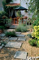 Private garden Kent Design Alan Titchmarsh Small Suburban town garden gravel with stepping stone slabs