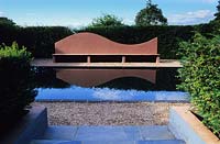 Veddw House Gwent formal reflecting pool with modern seat