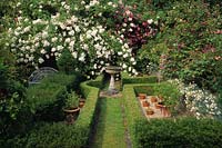 Alan Titchmarshs garden Hampshire Scented garden climbing roses with chamomile path boxwood hedges and bird bath as focal point