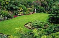 private garden Wolverhampton lawn in gently sloping garden with conifers and statue