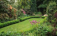 High Meadow Surrey oblong lawn with boxwood hedge border and mixed spring flowering border