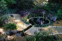 feng shui garden design Pamela Woods formal circular pool with sculptural fountian winding path and cool colour planting