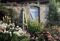Sussex design Fiona Lawrenson wooden painted obelisks in herbaceous perennial border