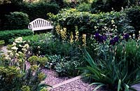 private garden London design Chris Moss small contemporary minimal town garden flower borders either side of path white bench
