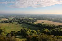 Sussex low weald South Downs Ditchling Beacon view across fields pasture green trees hedgrow traditional English England