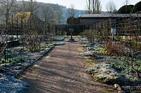 West Dean Sussex walled garden in winter frost path sun sunny shadows