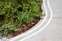 The Manchester Garden, view of subtle sinuous double rill following the course of the paving stones - Designer: Exterior Architecture, exteriorarchitecture.com. RHS Chelsea Flower Show 2019