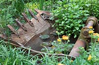 Walker's Forgotten Quarry Garden, metal digger bucket used to make an ingenious small pond. Design: Graham Bodle. Sponsor: Walkers Nurseries