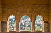 View from Palacio del Partal through ornate archways, The Alhambra, Granada.