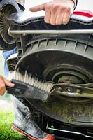 Lawn mower maintenance - cleaning blades with brush