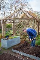 Digging over a bed in the vegetable garden before winter