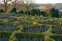 A view of the topiary and parterre garden at Broughton Grange, Oxfordshire.
