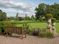 The bench is placed on the gravel patio and gives a view across the formal garden to the surrounding Herefordshire hills.