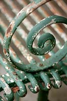 rusty metal detail of garden bench. 
