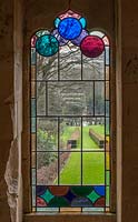 View through stained glass window to the garden
